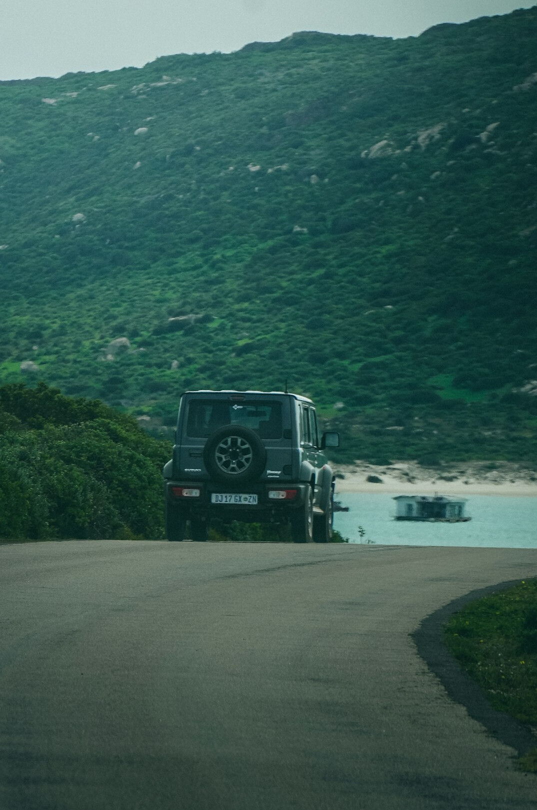 Luxury sports car driving on an open coastal road