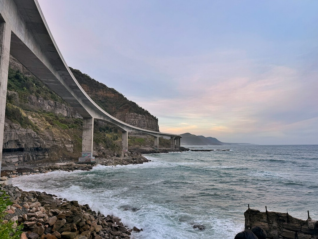 Coastal bridge road with ocean view at dusk