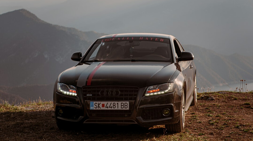 luxury car driving scenic road