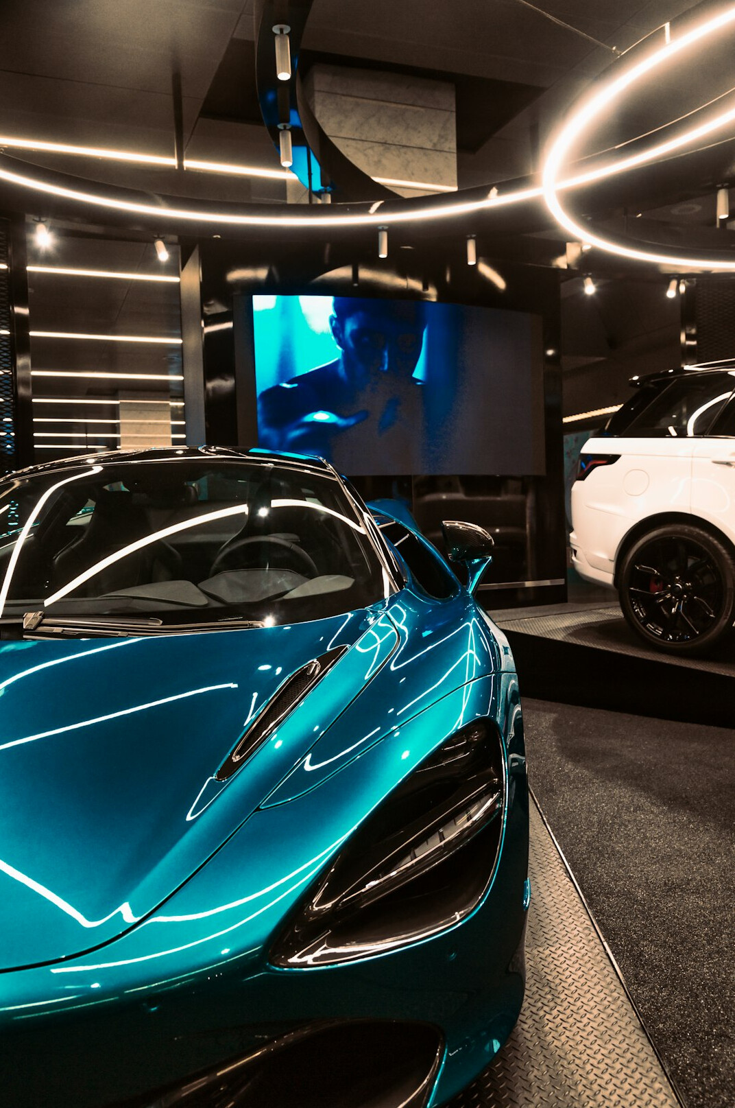 Modern hypercar displayed under dramatic showroom lighting