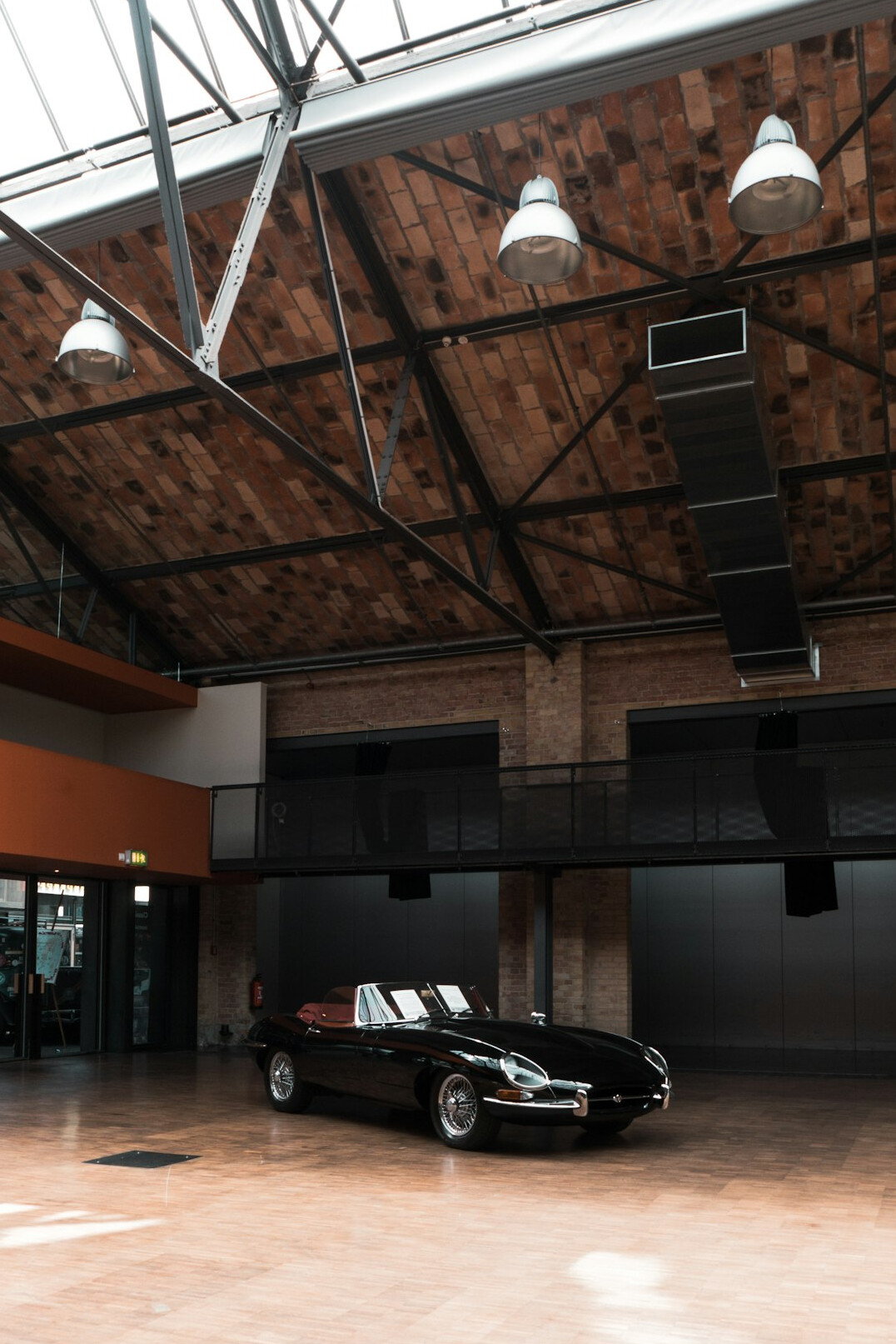 Vintage car displayed inside an elegant auction hall