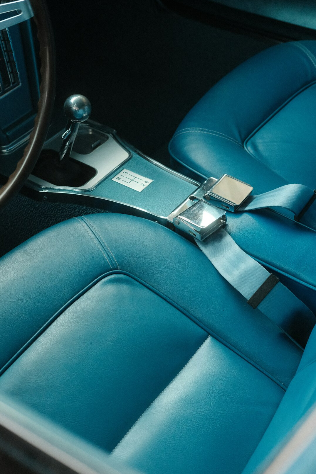 Dim lit interior of a vintage car with leather seats