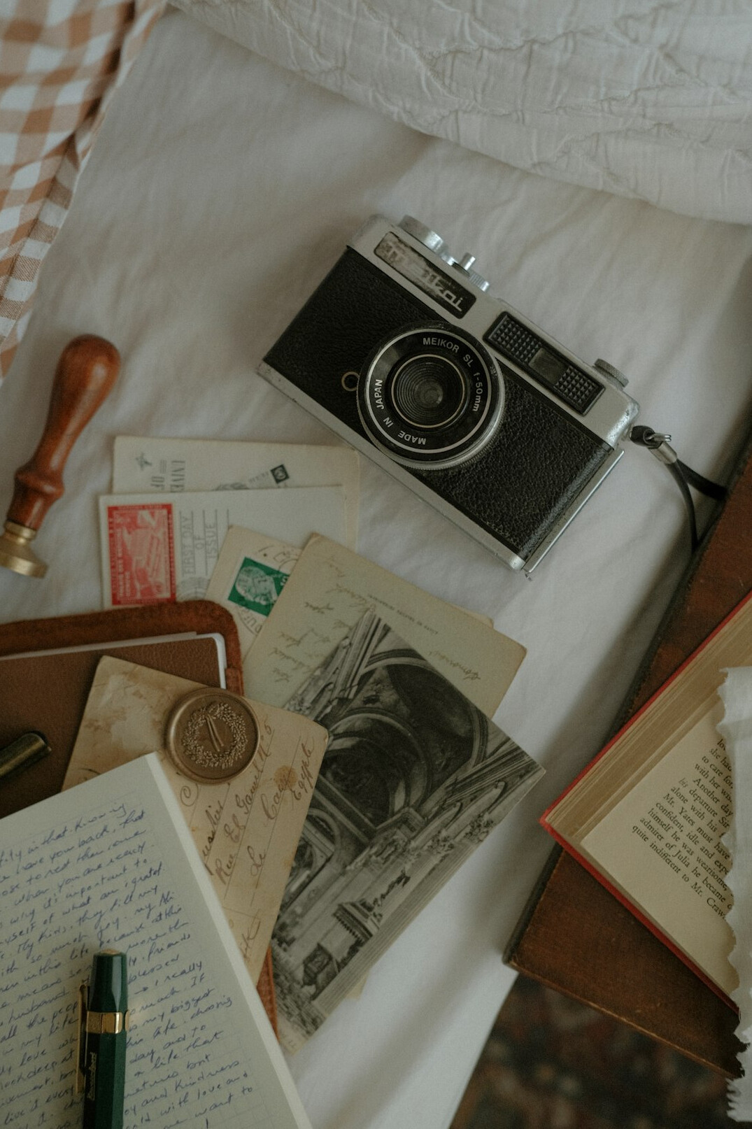 Desk with archival photographs, notebook and camera