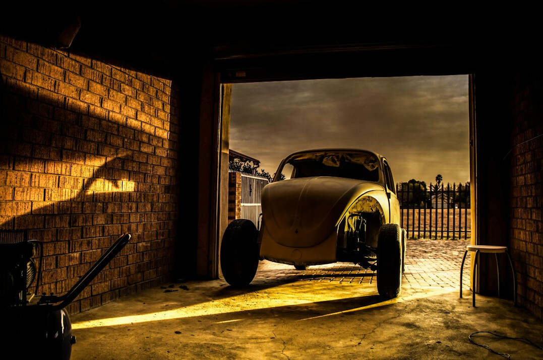 Silhouette of a classic car in a dark private garage